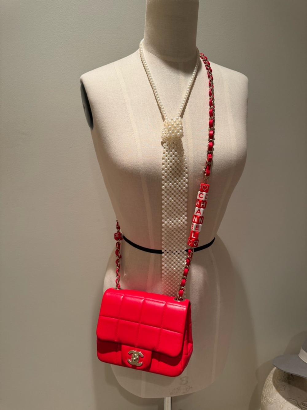 CHANEL Pink-Red Quilted Leather Crossbody with Logo Charm Strap